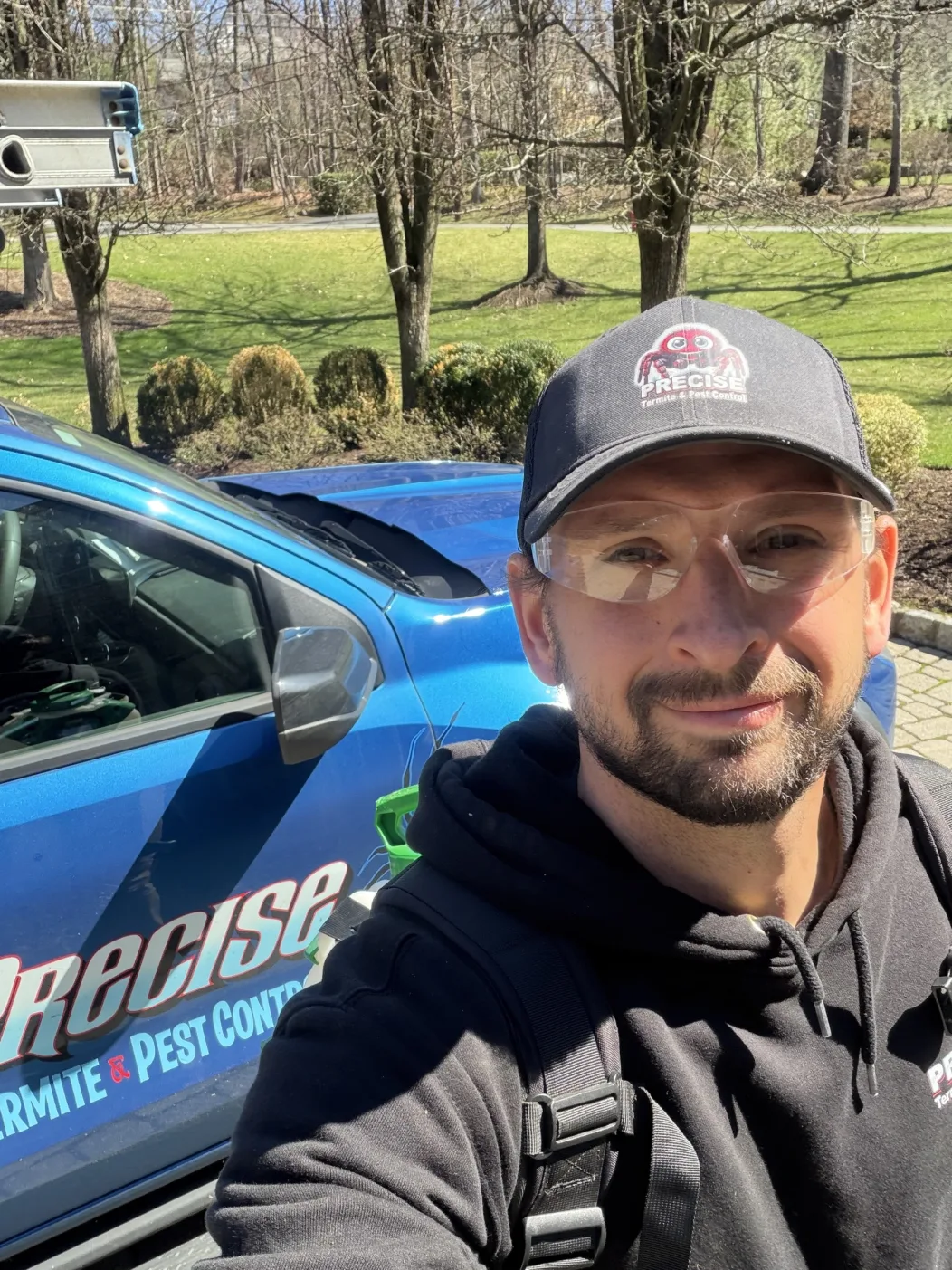Precise Pest Control technician next to a company truck