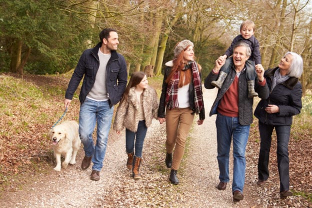 Family Walking Dog Through Woods in the Fall