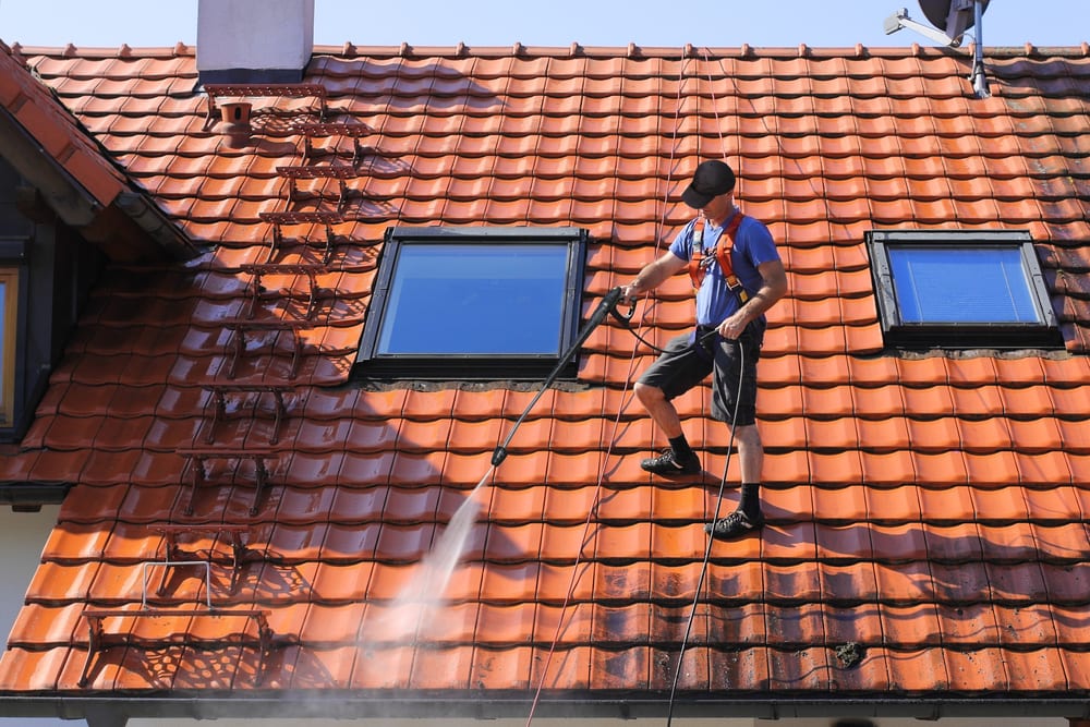 Man Soft Washing a Roof