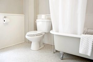 Bathroom interior with claw foot bathtub.